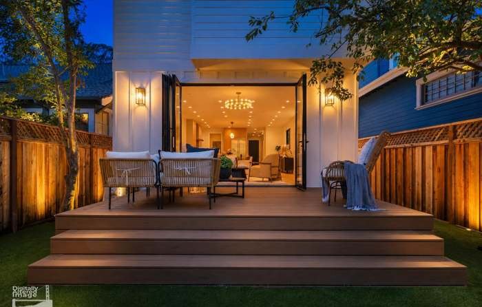 Rear deck and folding glass wall lit at dusk